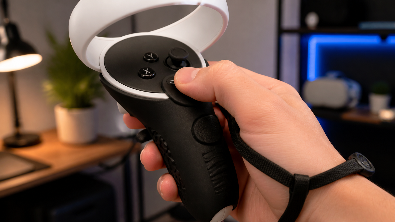 A close-up view of a thumb pressing the menu button on a Quest 2 controller covered by a grip.