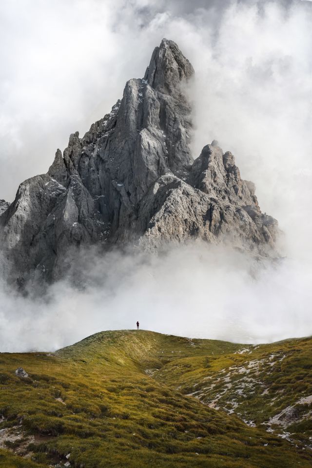 Misty mountain top above a mossy hill