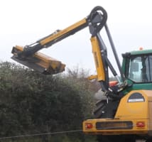 A McConnel hedge cutting fitted on a John Deere tractor hedge cutting