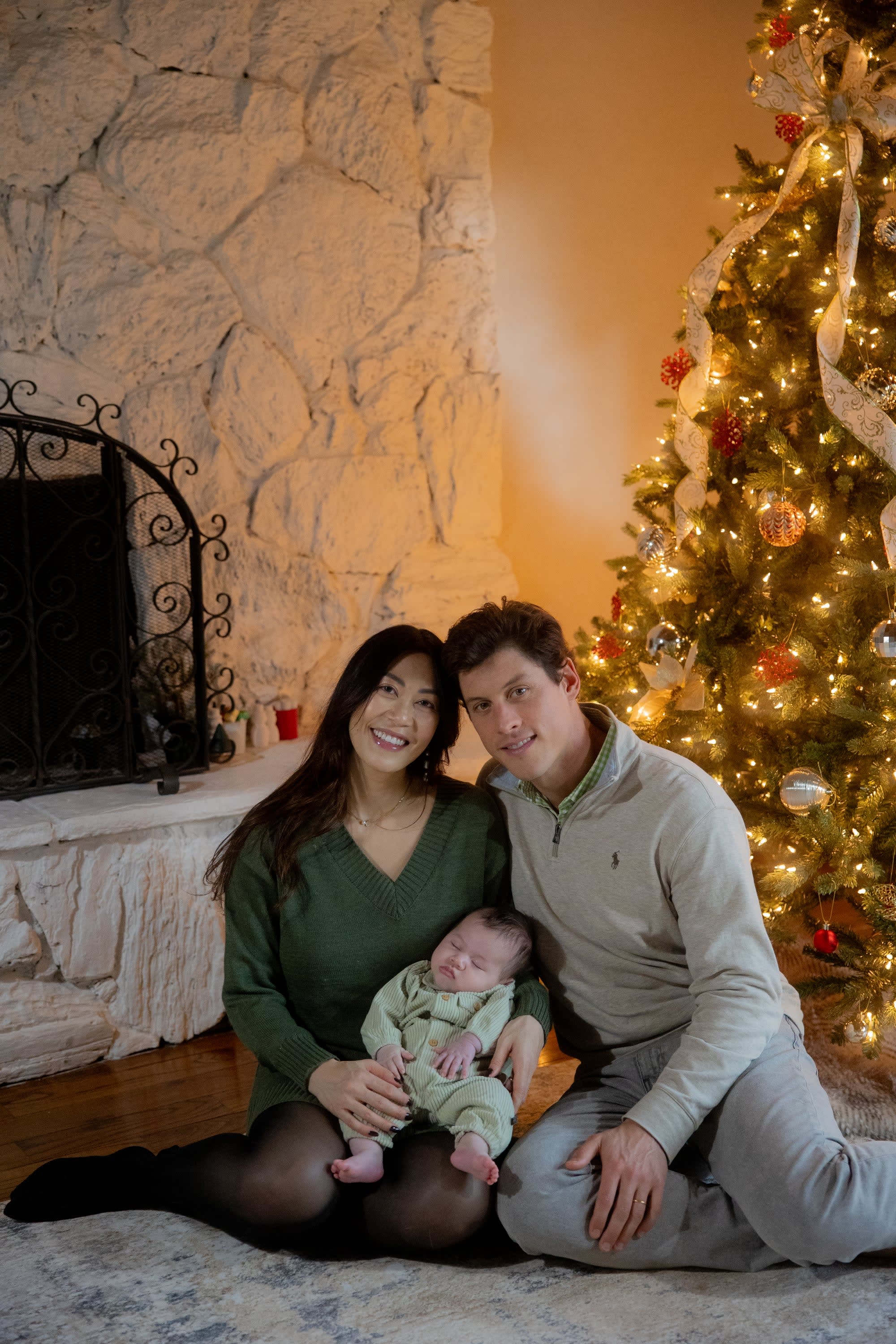 family photo by christmas tree on the floor