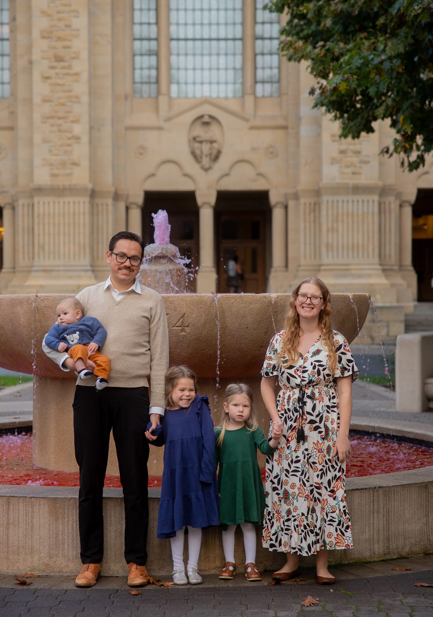 family photo by christmas tree on the floor