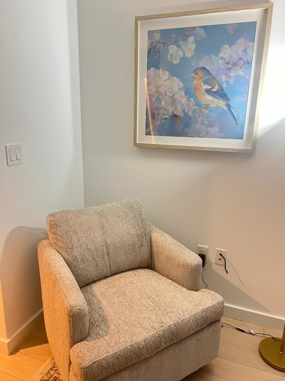 Cozy chair with bird artwork.