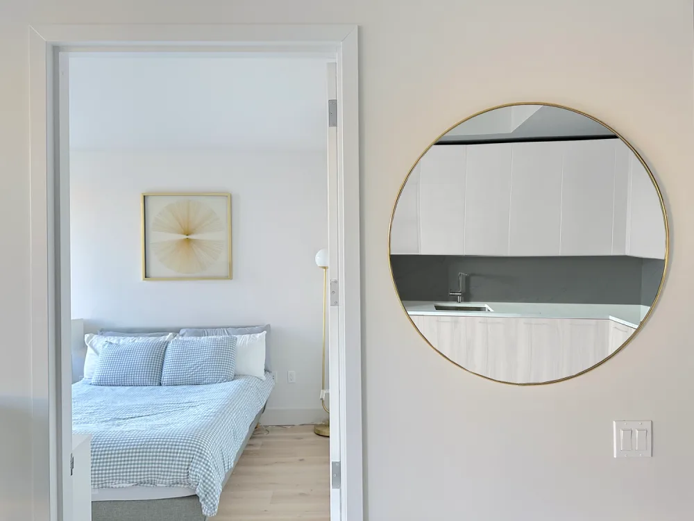 Modern minimalist bedroom and kitchen reflection.