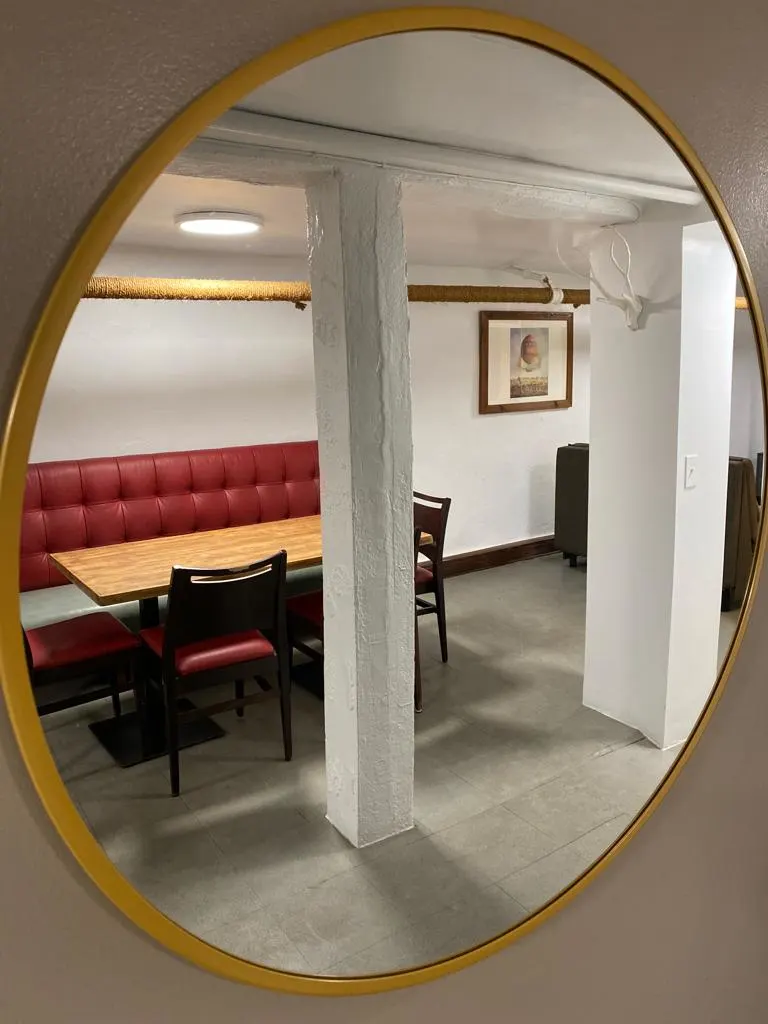 Elegant dining nook with mirror.