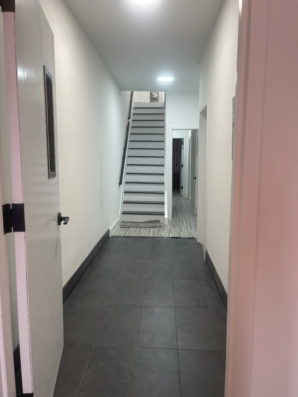 Clean hallway with stairs ahead.