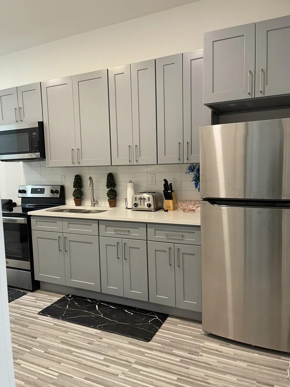 Modern kitchen with grey cabinets.