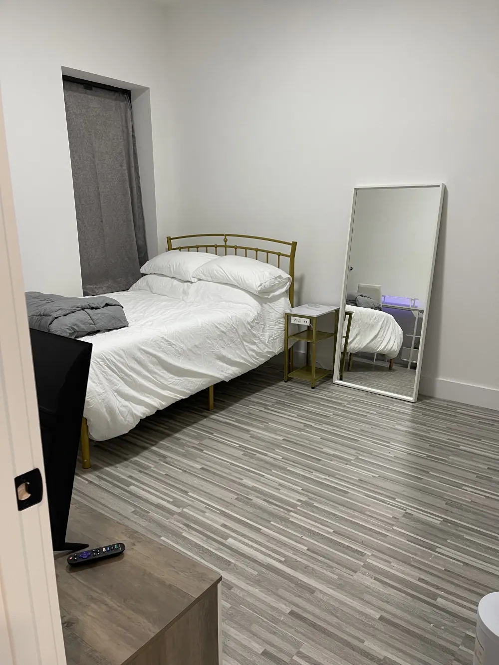 Modern bedroom with minimal furnishings.