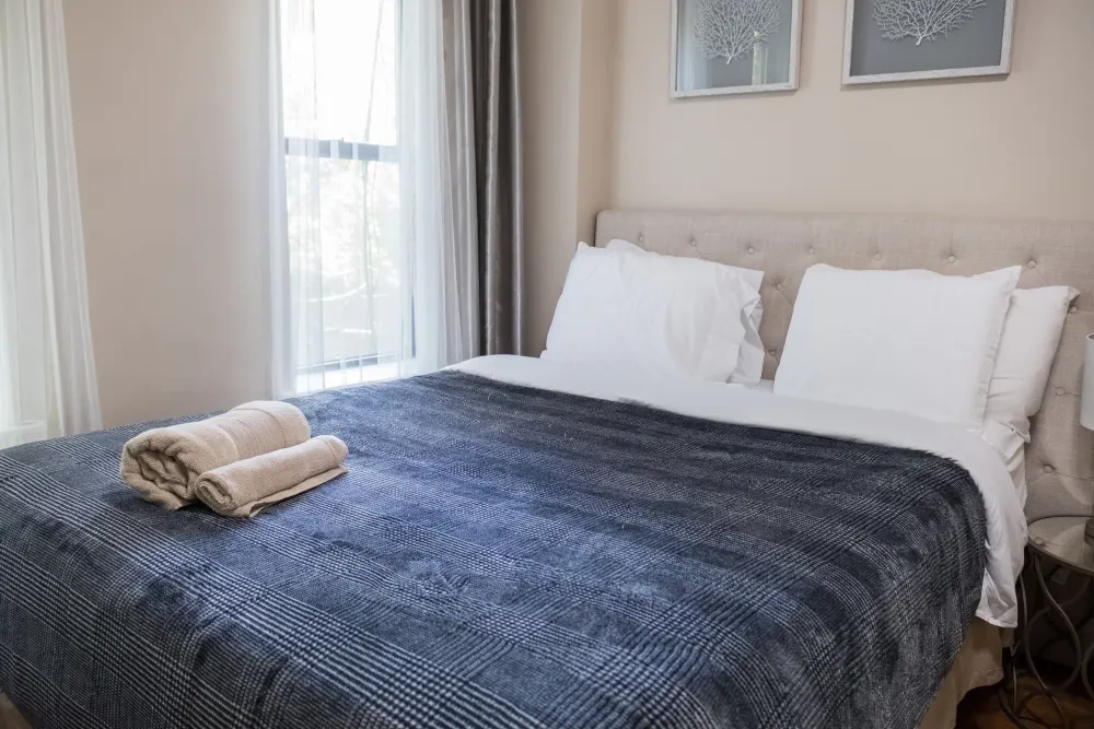 Cozy bedroom with ample sunlight.