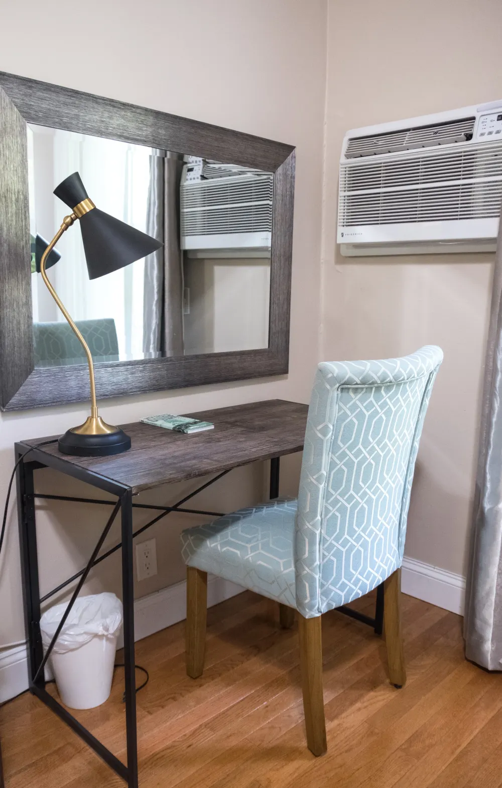 Compact desk with mirror and lamp.