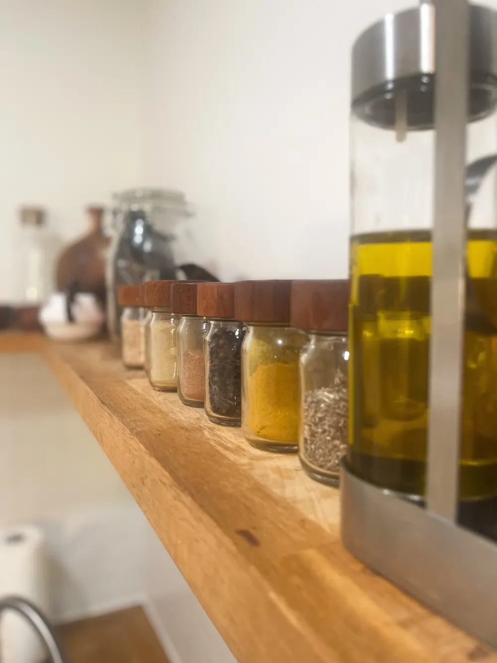 Jars of spices on shelf.