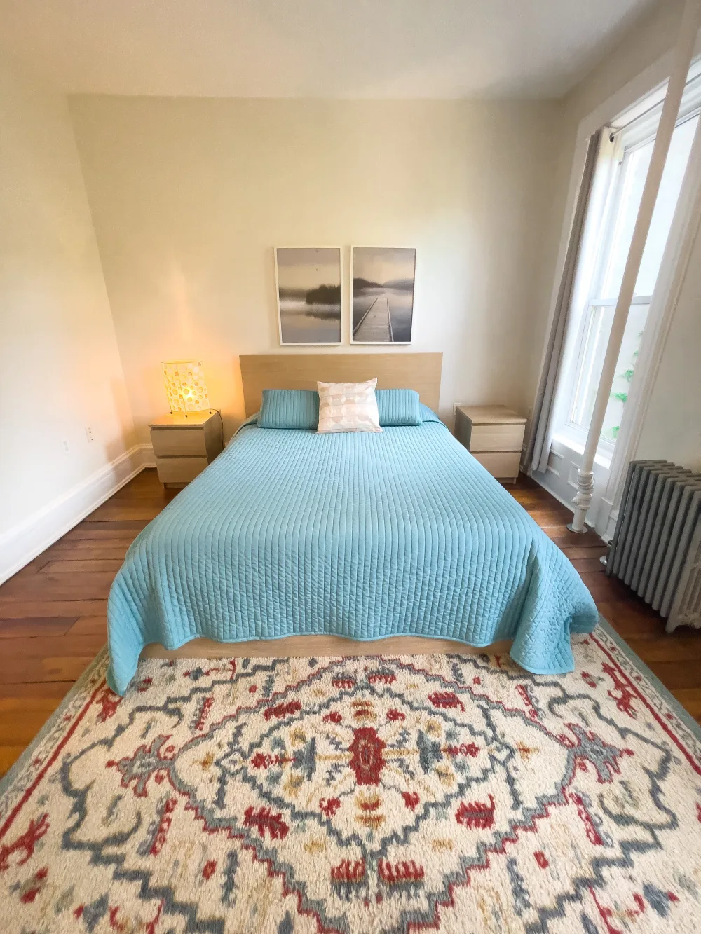 Cozy bedroom with blue bedspread.