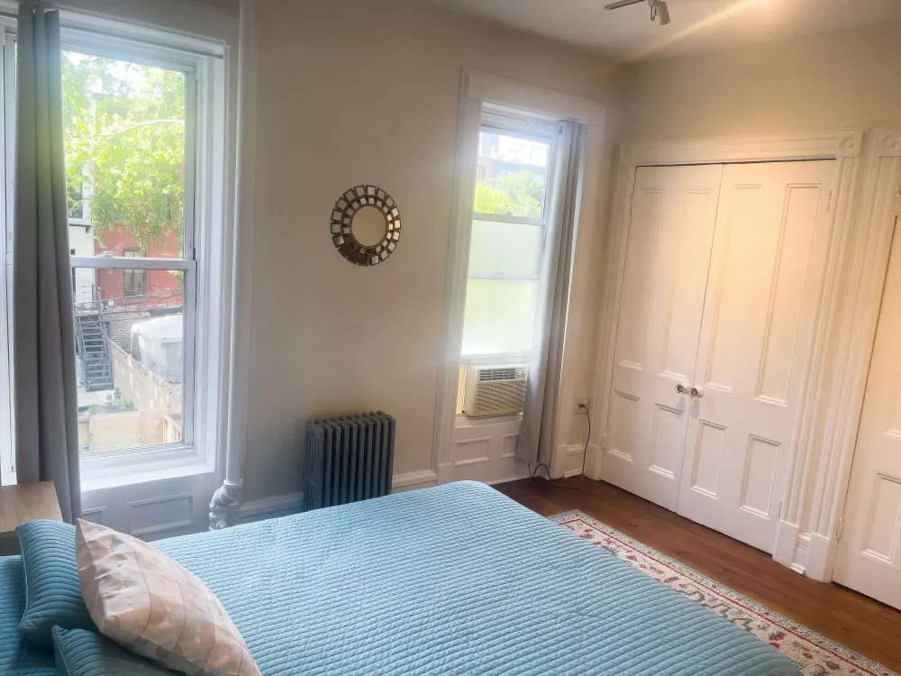 Cozy bedroom with large windows.