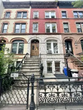 Brownstone building with a staircase.