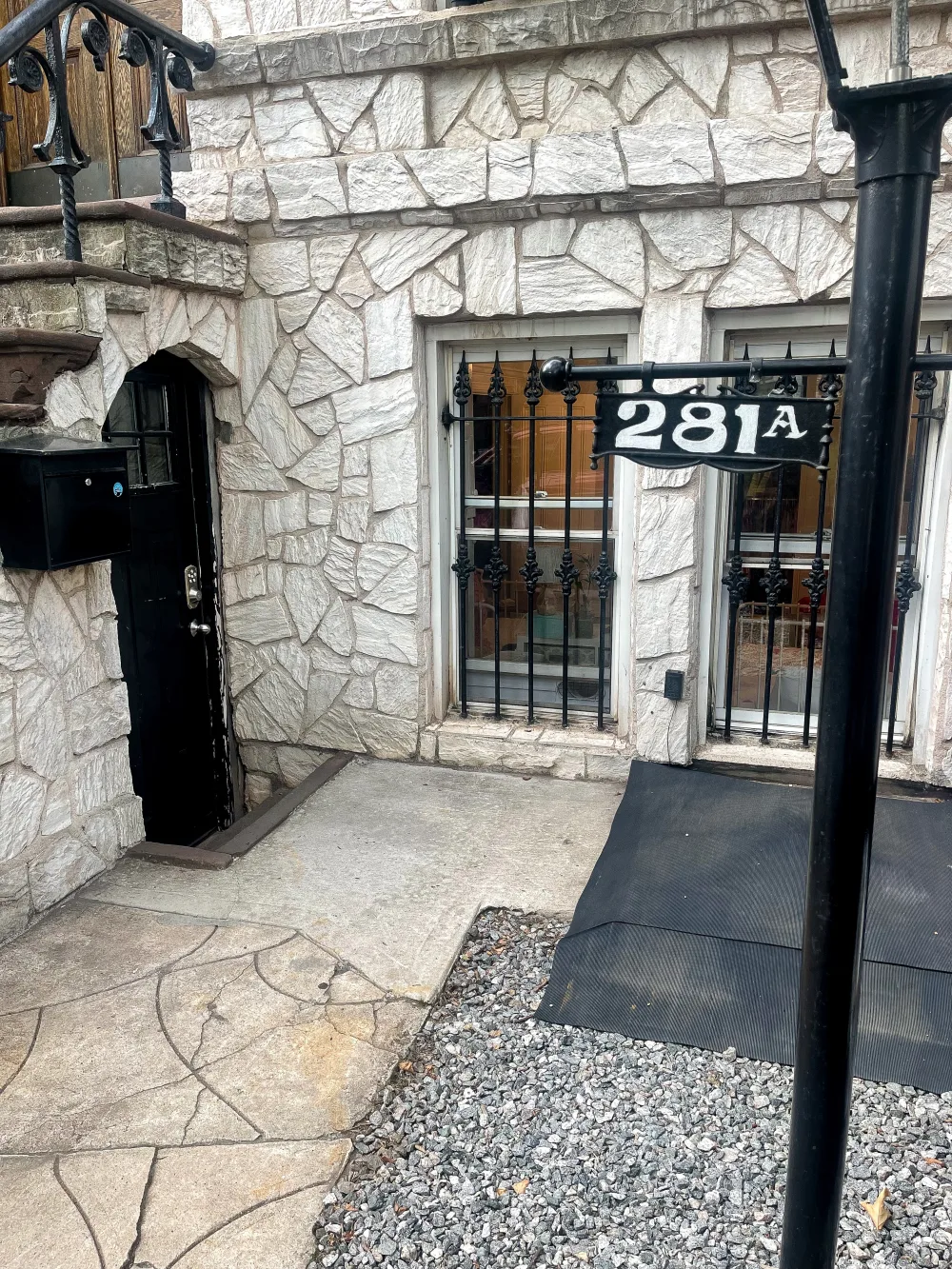 Stone building entrance with apartment number.