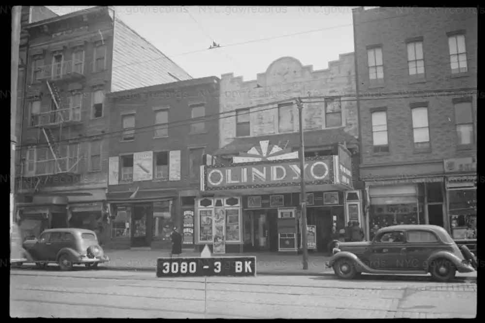 Vintage movie theater with cars.