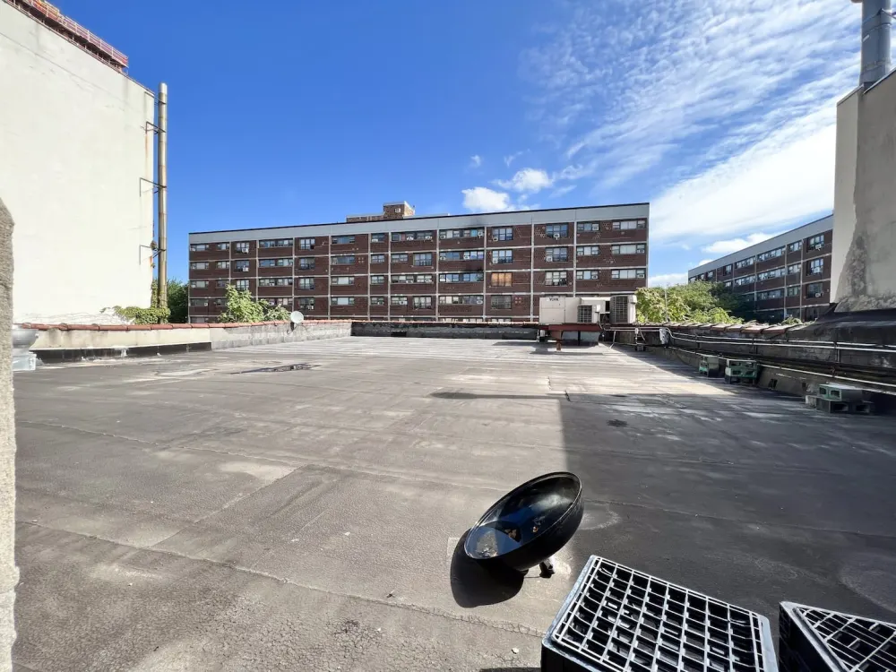 Urban rooftop with blue sky.