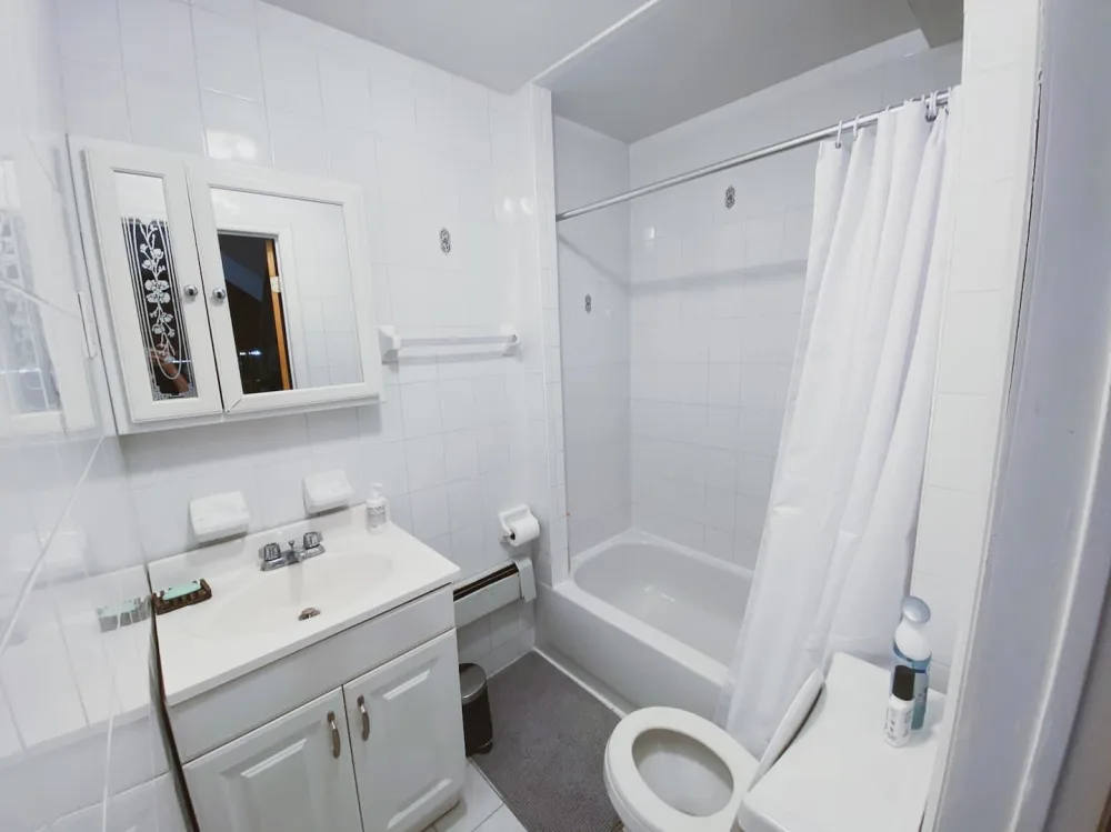 Small, clean bathroom with bathtub.