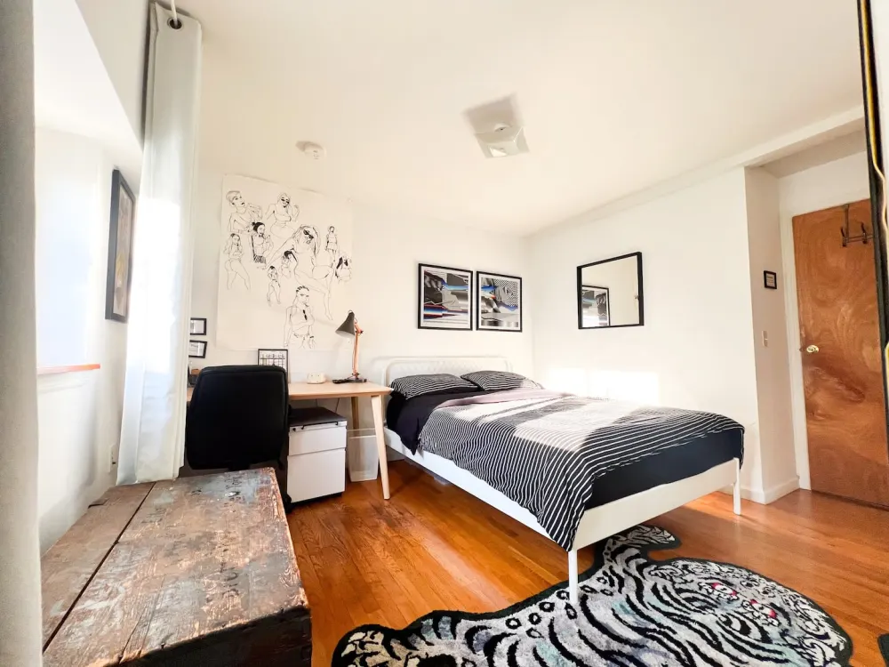 Bright, modern bedroom with artwork.