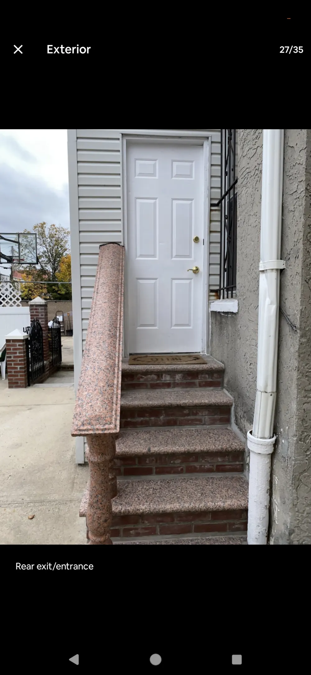 White door, stone steps, railing.