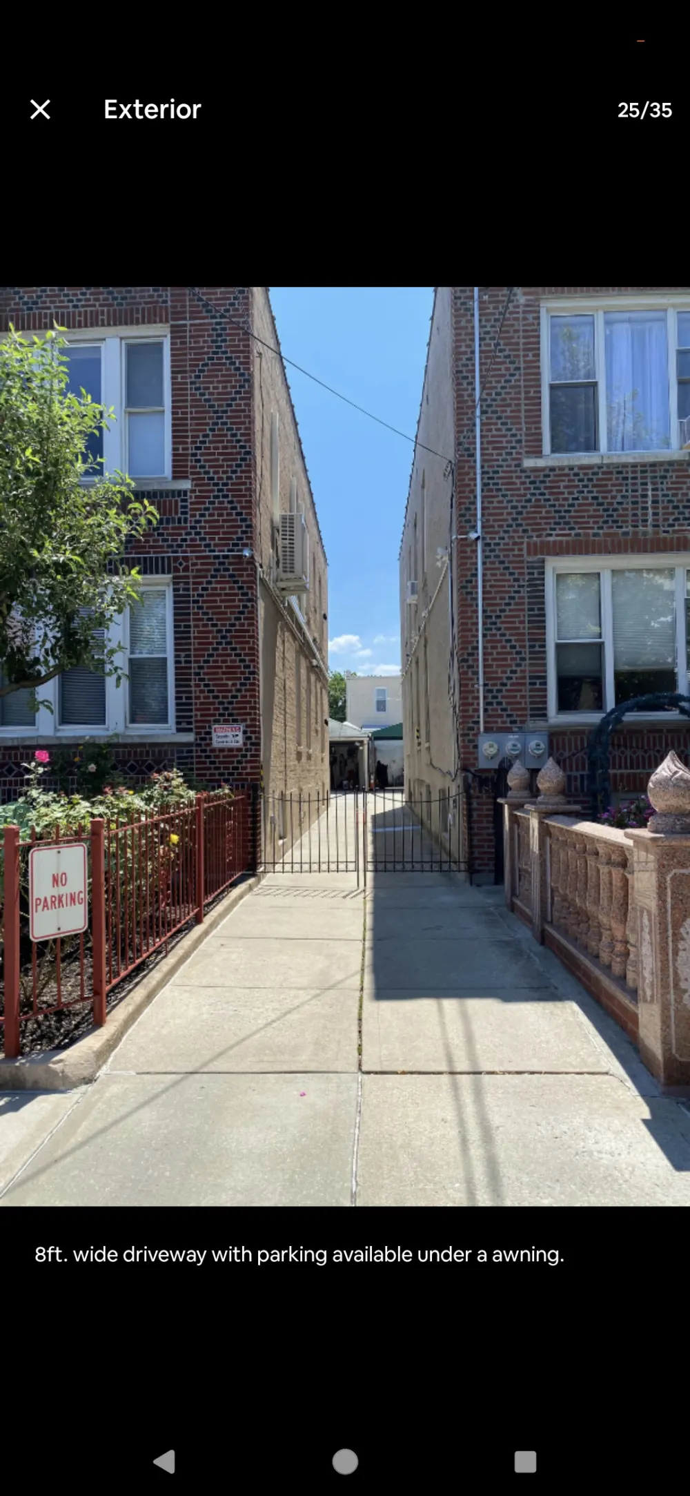 Narrow brick building driveway entrance.