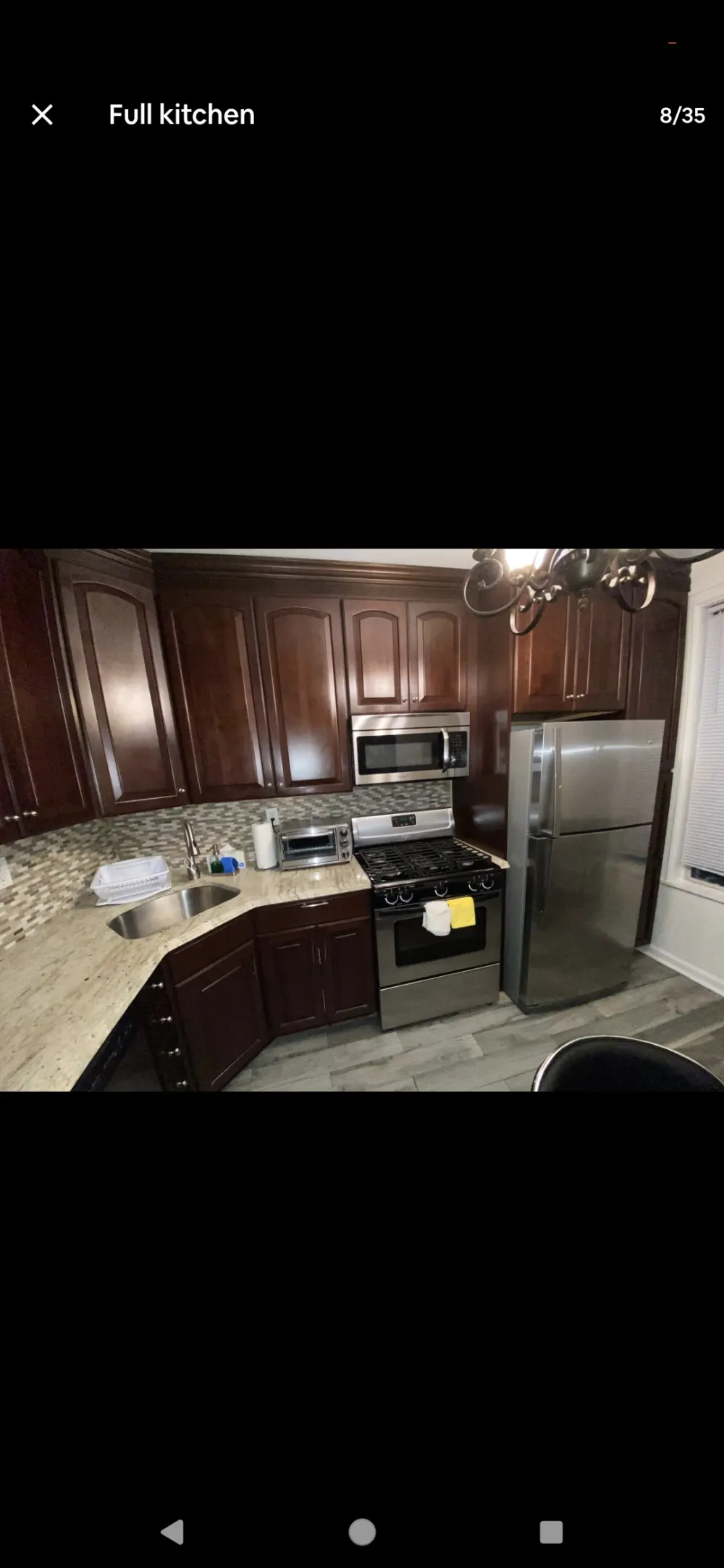 Modern kitchen with stainless appliances.