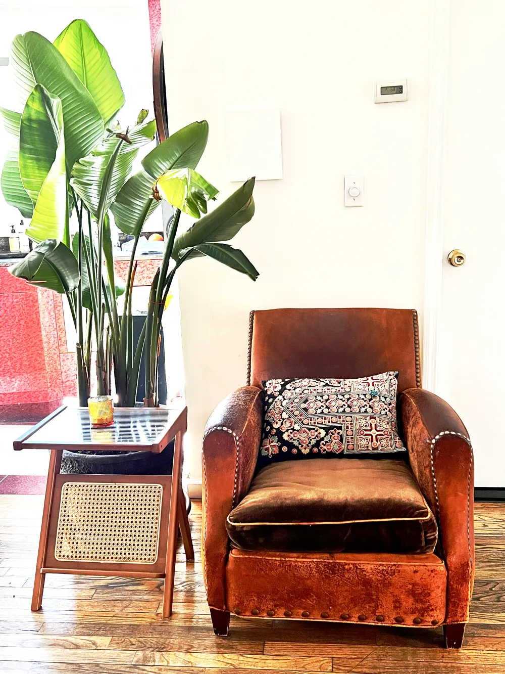 Cozy chair with decorative pillow.