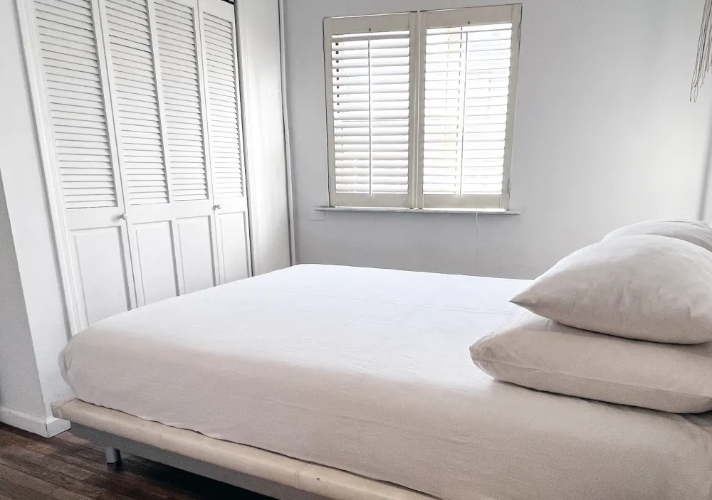 Minimalist bedroom with white decor.