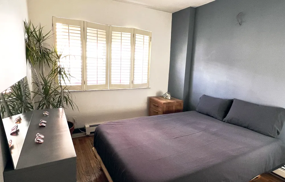 Minimalist bedroom with gray bedding.