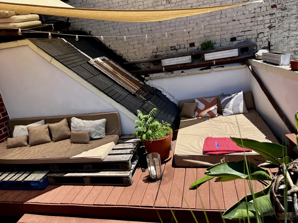 Cozy rooftop lounge with cushions.