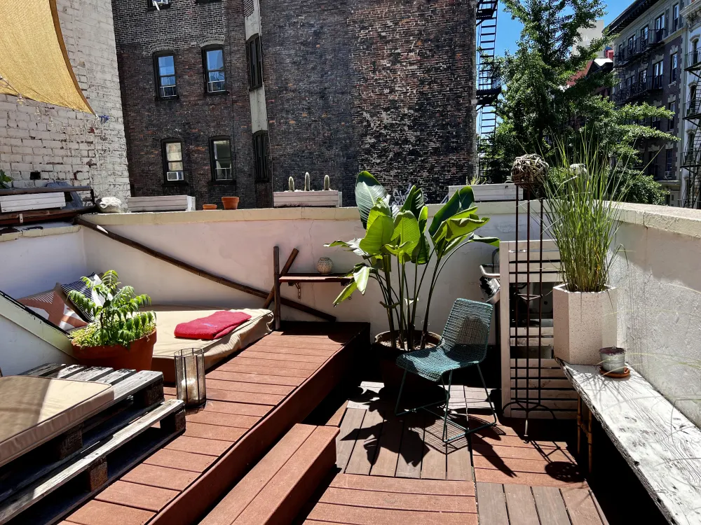 Cozy rooftop patio with plants.