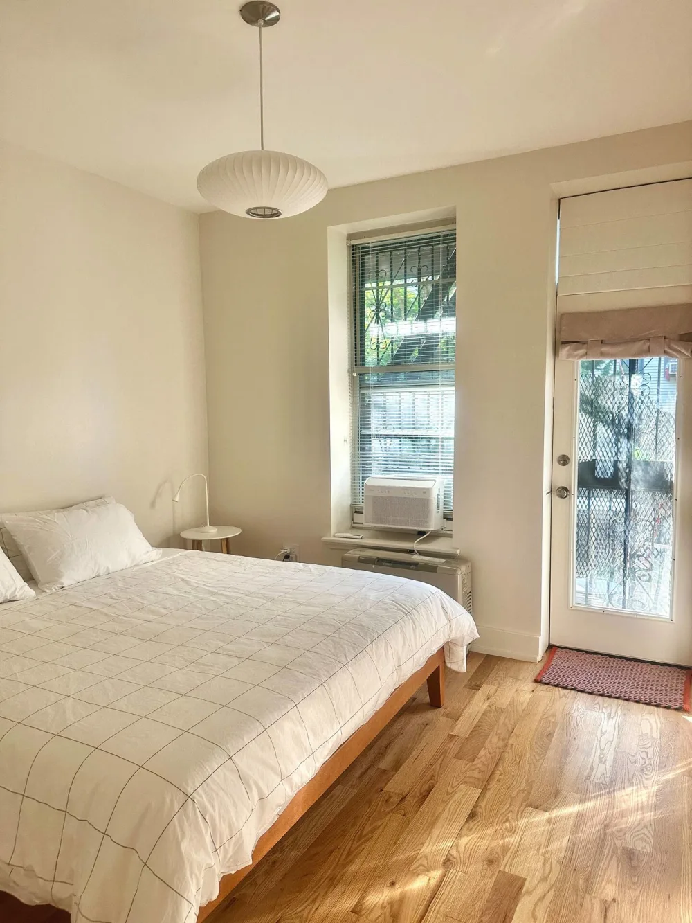 Bright, minimalist bedroom with window.