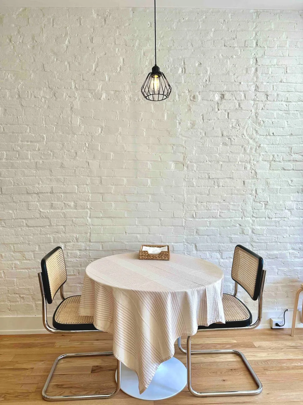 Minimalist dining set, brick wall.