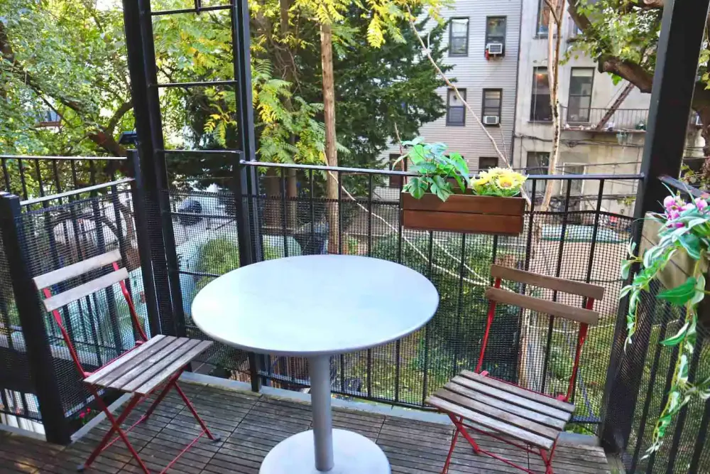 Cozy balcony with table, chairs.
