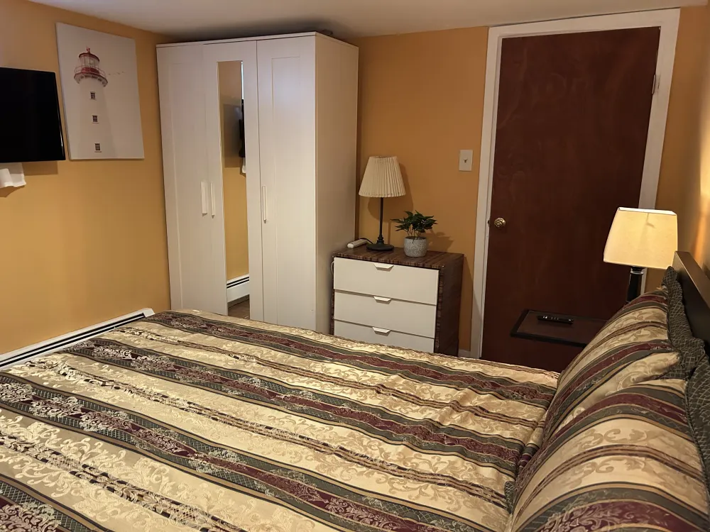 Cozy bedroom with striped bedding.