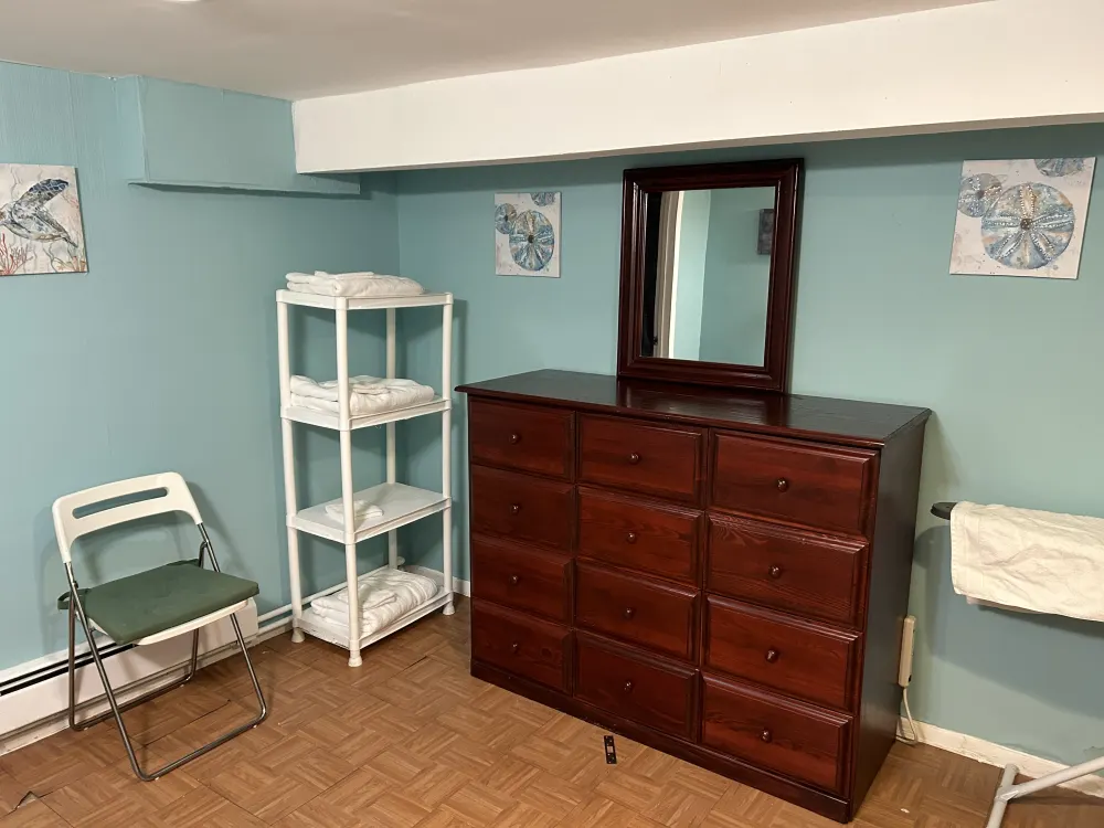 Cozy room with wooden dresser.