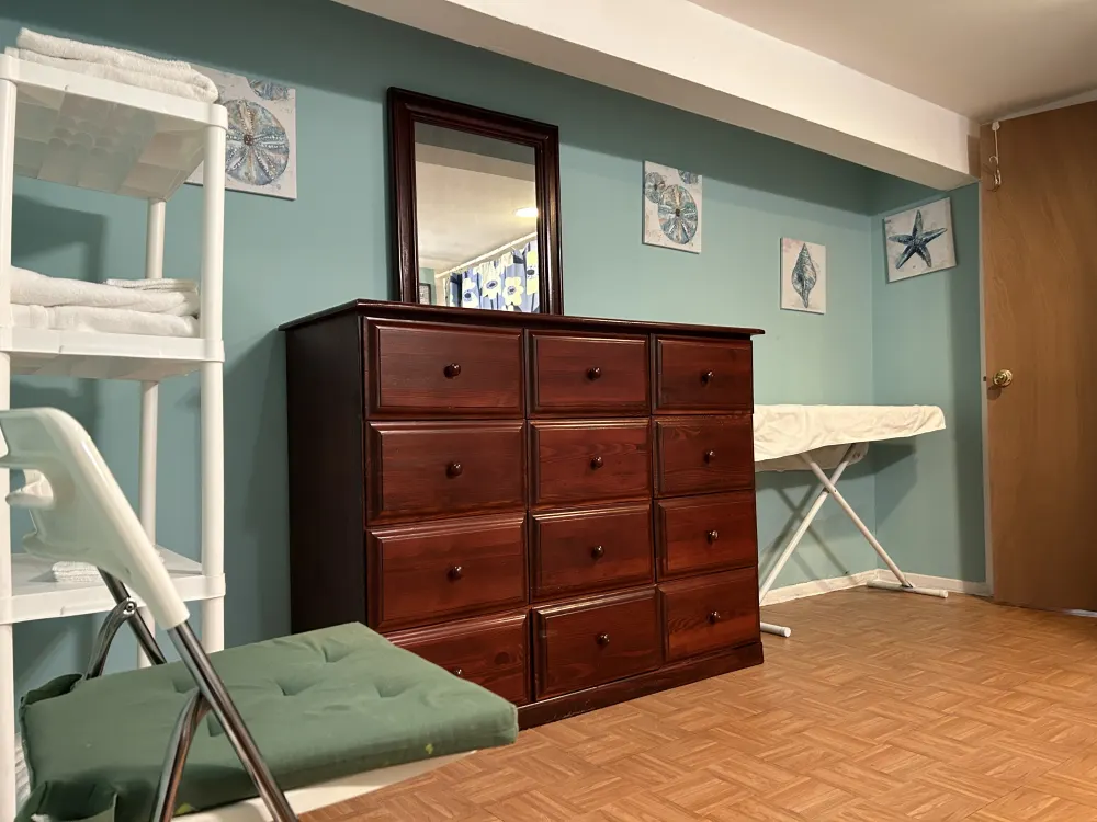 Cozy room with wood dresser.