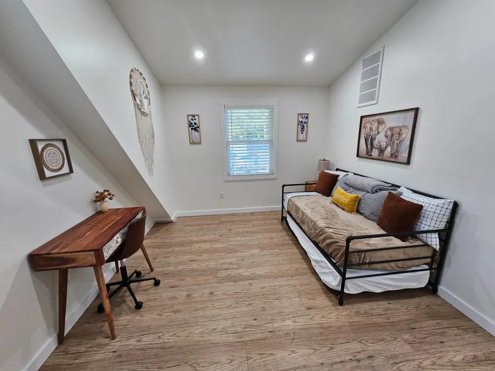 Cozy room with daybed, desk.