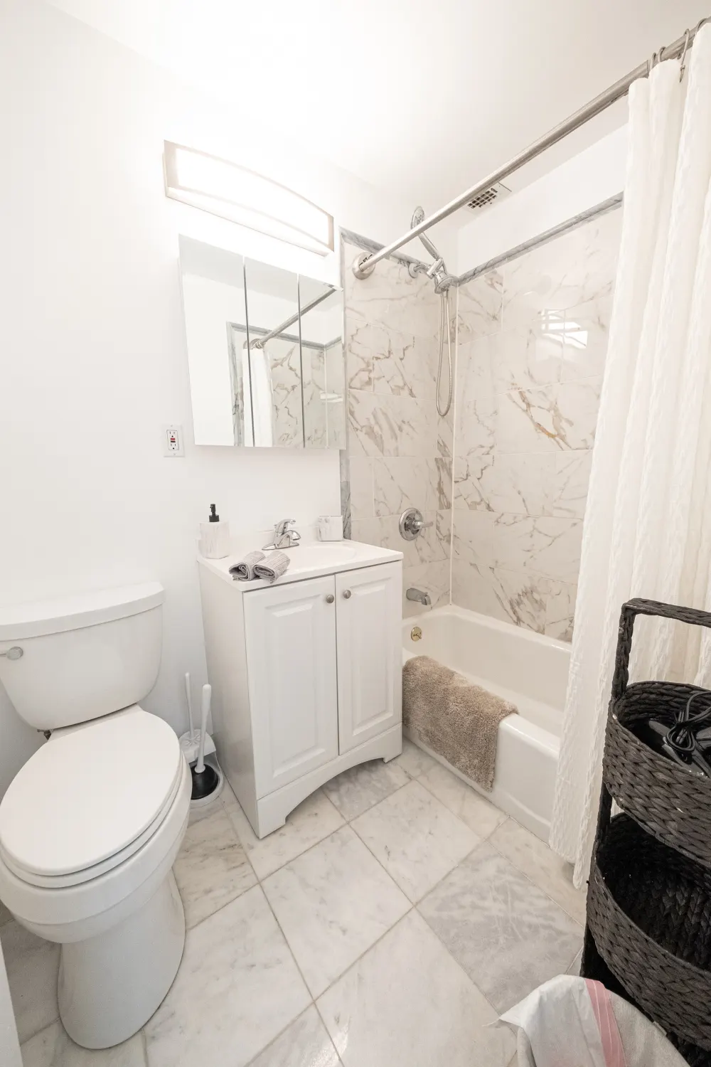 Modern, clean white bathroom space.