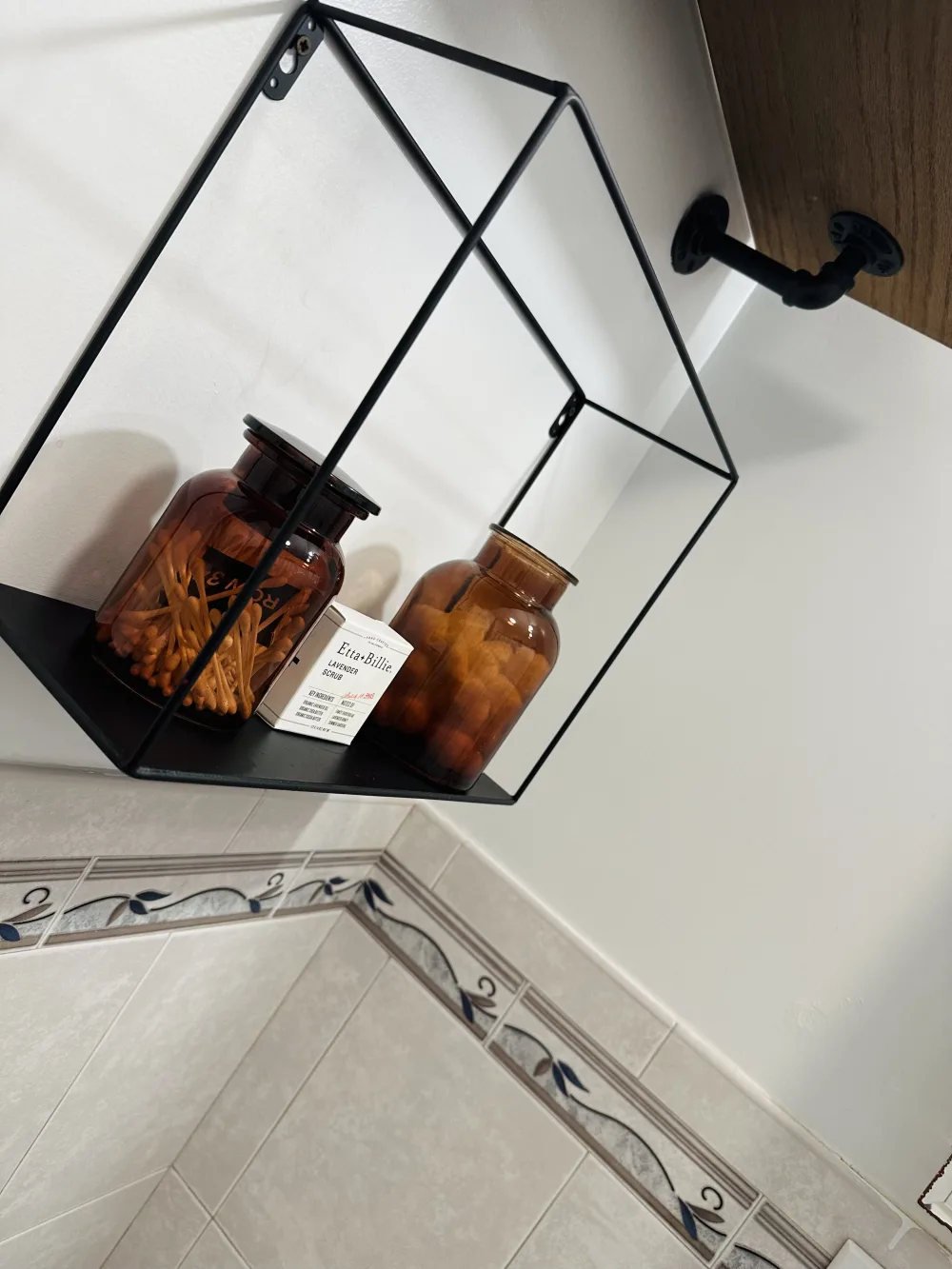 Bathroom shelf with decorative jars.
