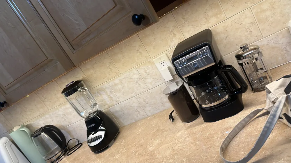 Modern kitchen counter with appliances.