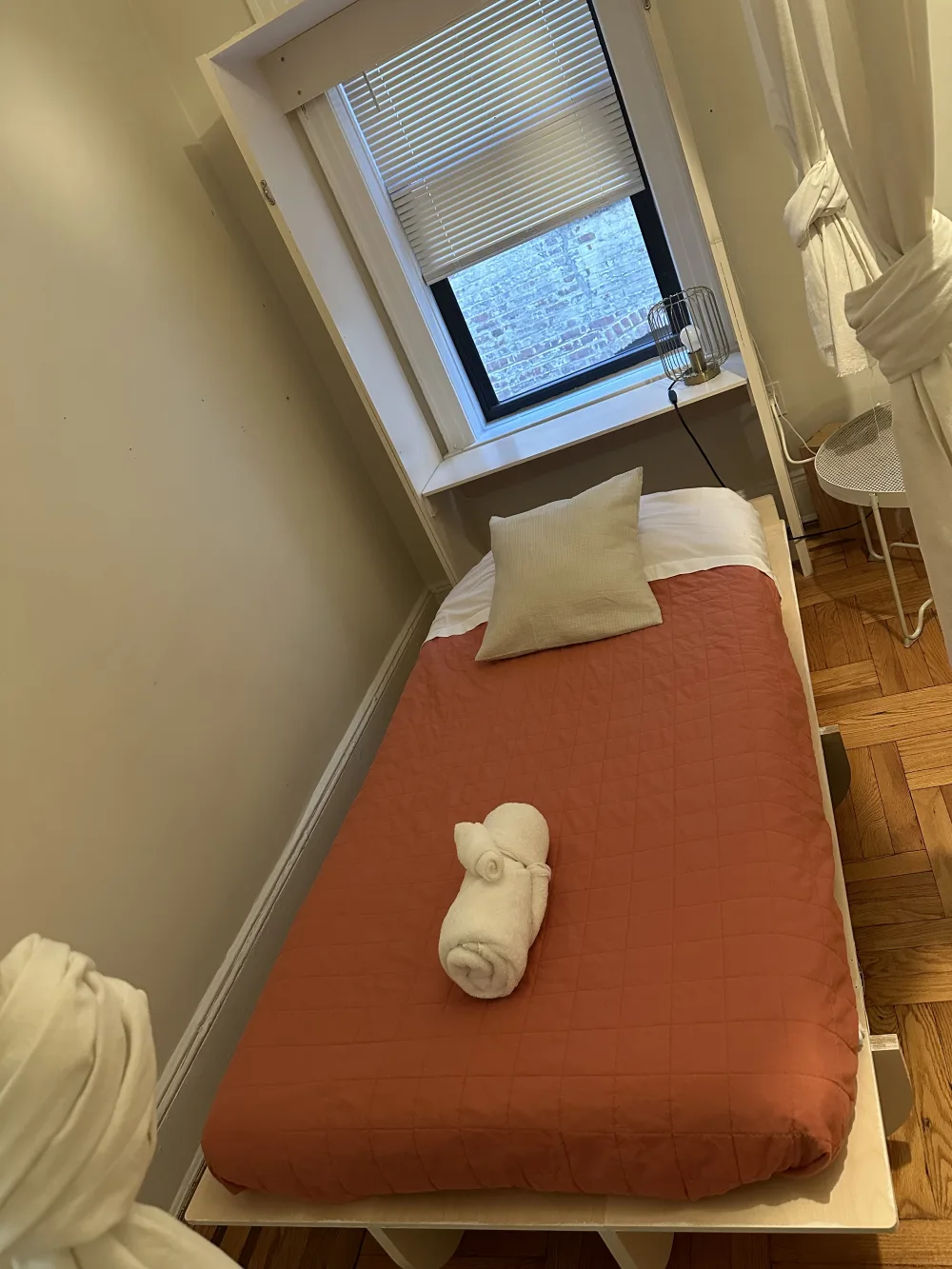 Compact cozy bedroom with window.