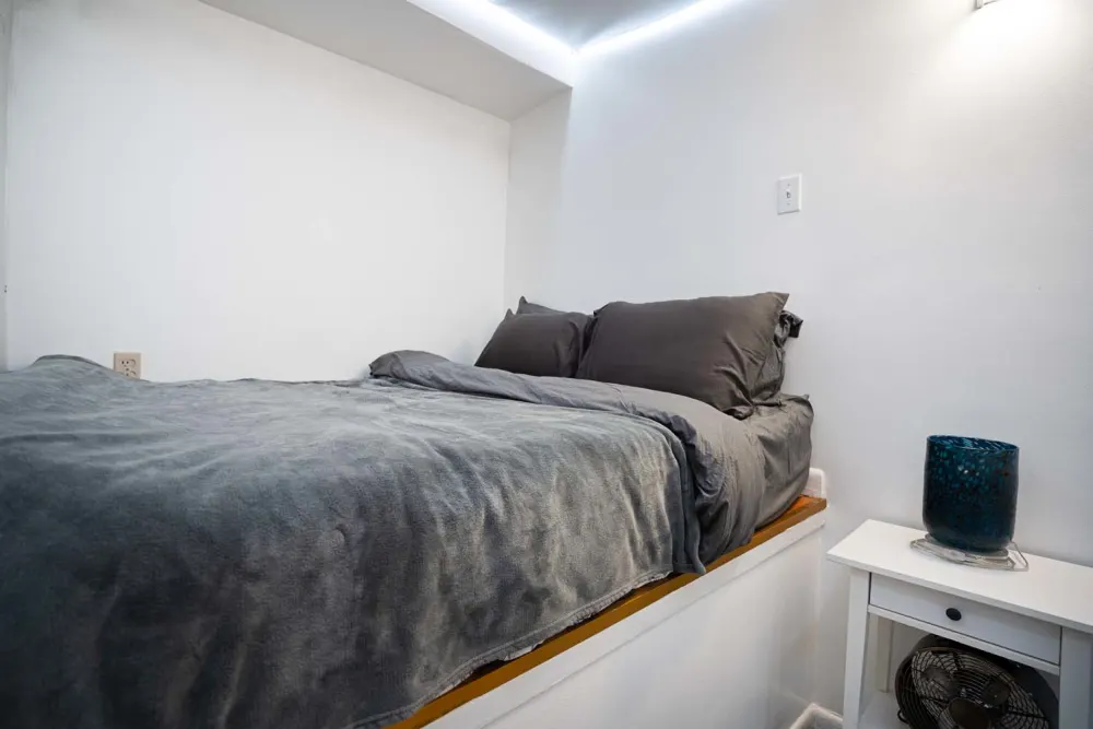 Cozy bedroom with grey bedding.