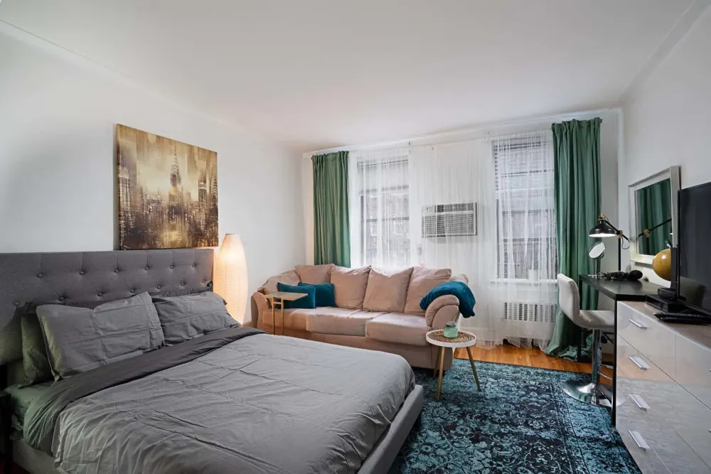 Cozy studio apartment with sofa.