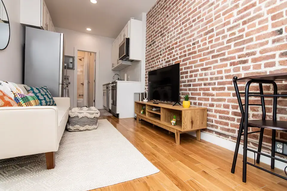 Modern apartment with exposed brick wall.