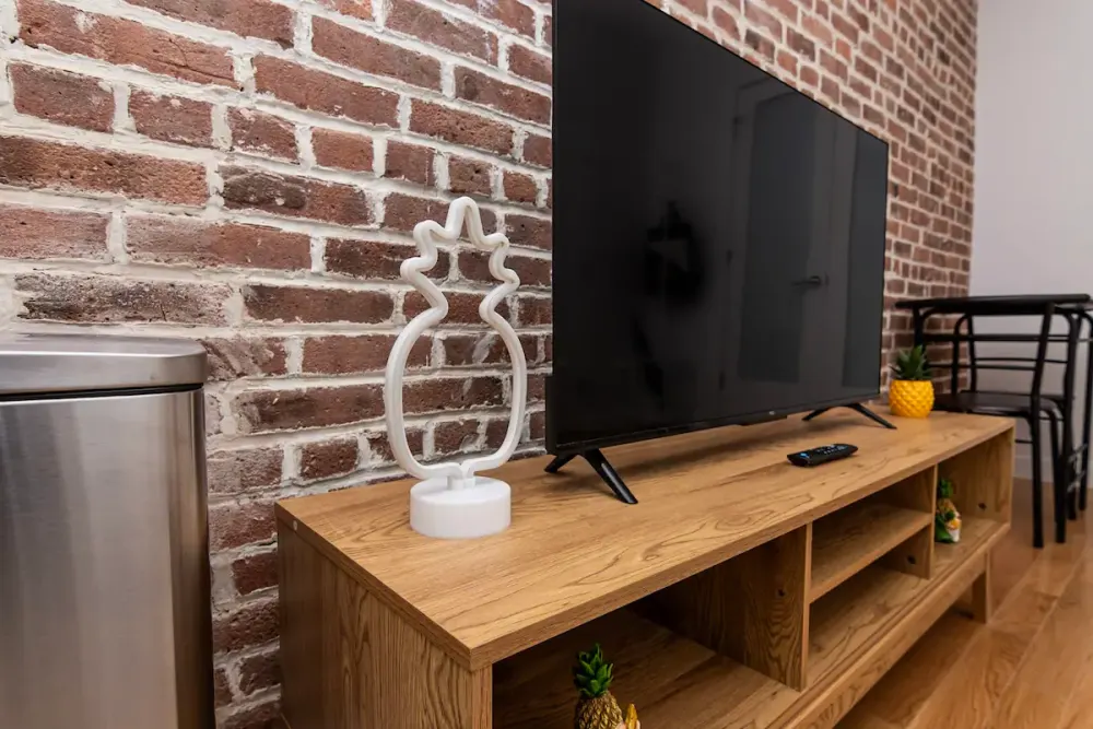 Modern TV setup with brick wall