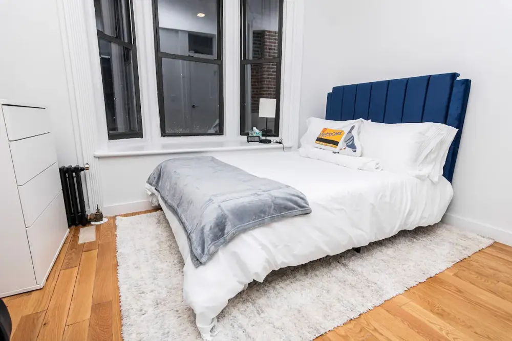 Modern bedroom with large windows.