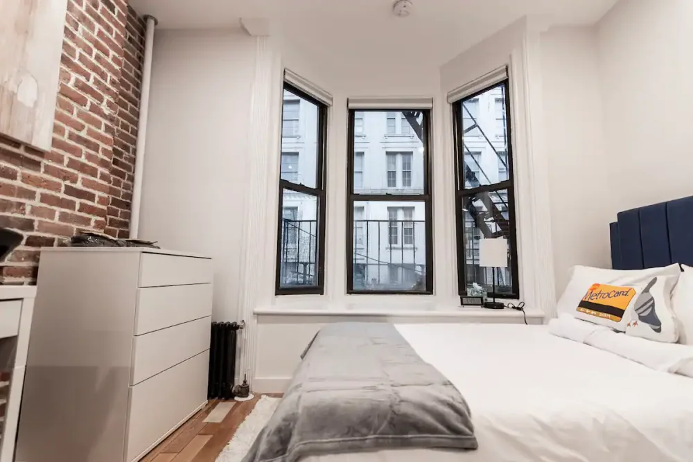 Cozy bedroom with large windows.
