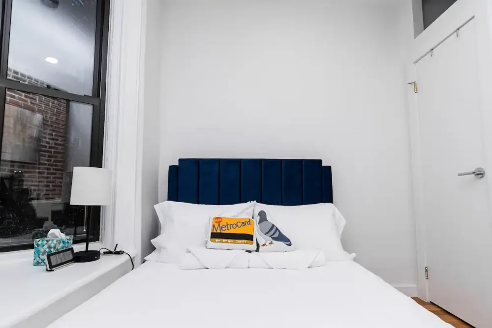 Modern bedroom with quirky pillows.