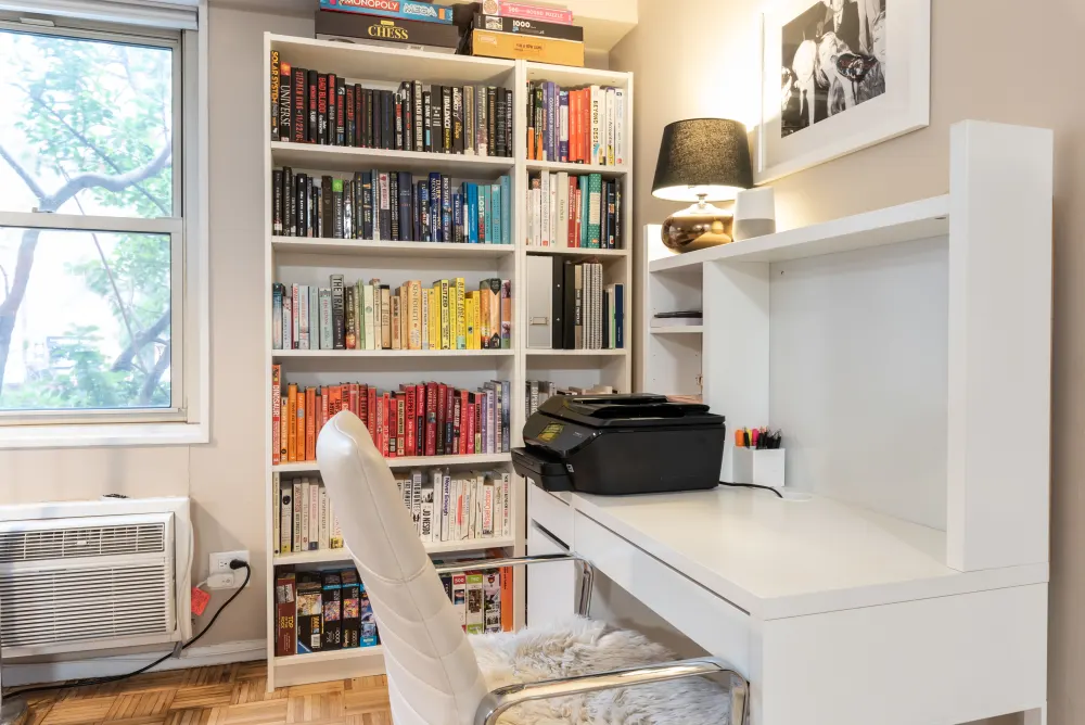Cozy study with organized bookshelf.