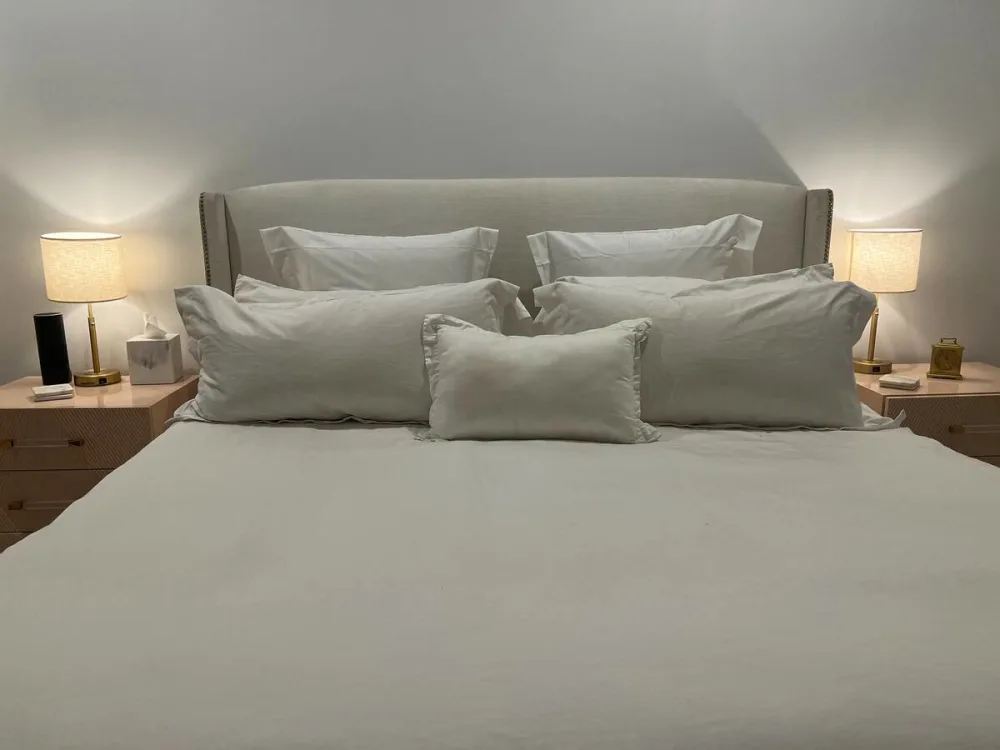 Cozy bed with nightstands lit.